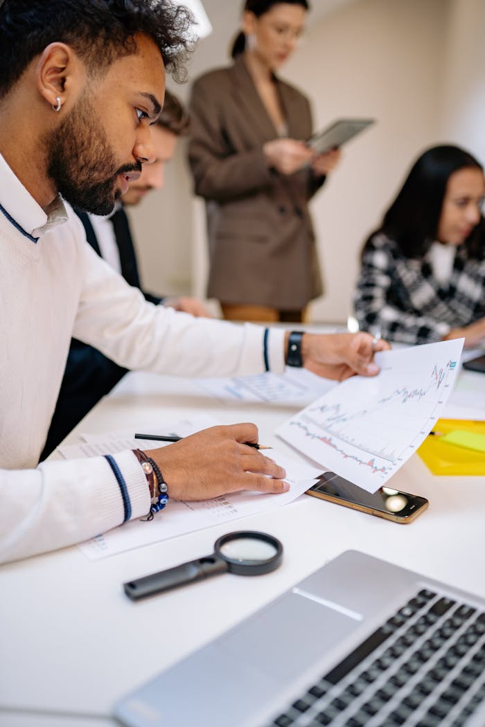 services-02 Focused professionals analyzing documents in a collaborative business meeting setting.